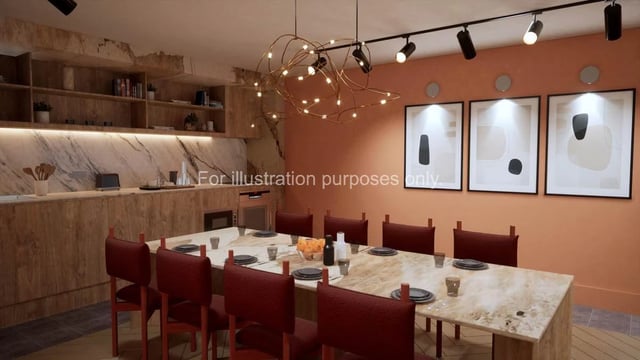 Dining table with chairs kitchen area artwork communal room at The Fabric Works in Leeds Student Accommodation