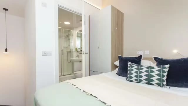 Bed with pillows wardrobe visible bathroom bedroom at Gillows in Lancaster Student Accommodation