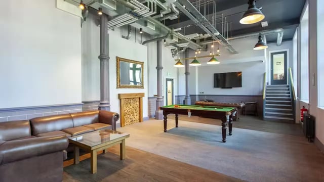 Leather sofas pool table fireplace common room at Gillows in Lancaster Student Accommodation