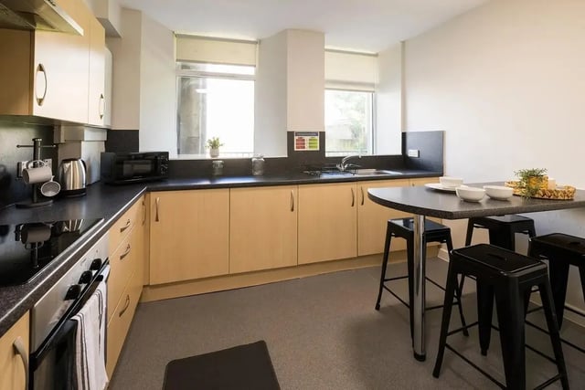 Kitchen with cabinets microwave and breakfast bar kitchen at Lyon Street Terrace in Dundee Student Accommodation