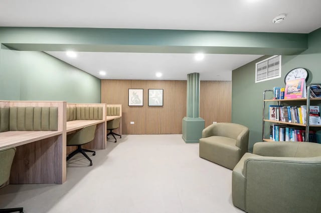Desks chairs and bookshelves communal area at Cathedral Park in Bristol Student Accommodation
