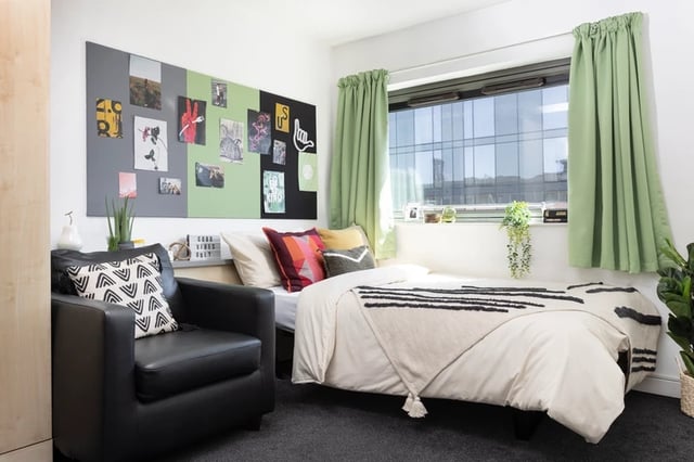 Black armchair bed with decorative pillows and blanket Bedroom at Sir Charles Groves Hall in Manchester Student Accommodation
