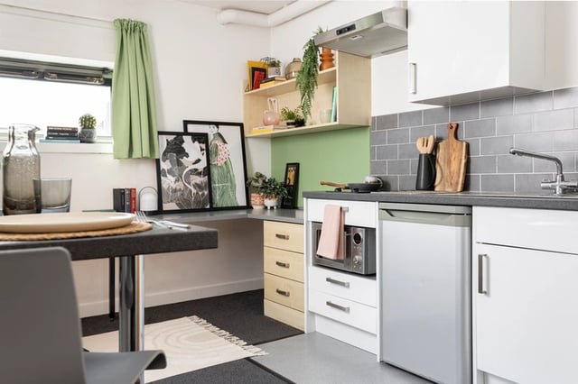Small kitchen with microwave fridge and table kitchen at Sir Charles Groves Hall in Manchester Student Accommodation