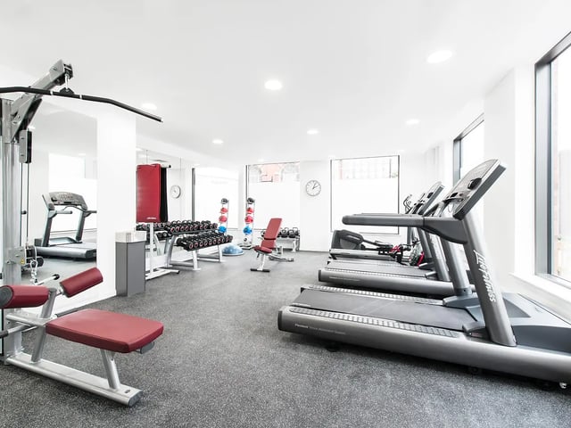 Treadmills weight racks and gym equipment gym room at Yugo Bentley House in Birmingham Student Accommodation