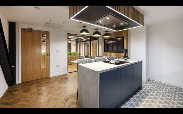 Modern kitchen island with stove and dining area kitchen at Medici in Nottingham Student Accommodation