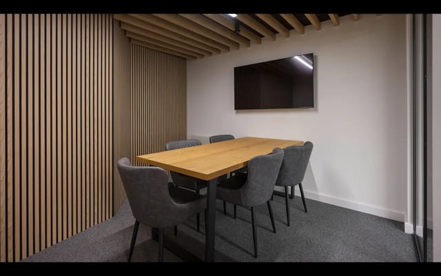 Wooden table chairs and TV meeting room at Medici in Nottingham Student Accommodation