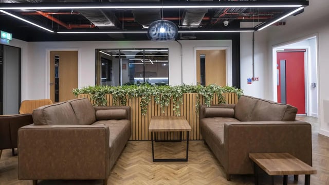 Two brown sofas with tables plants living room at Medici in Nottingham Student Accommodation