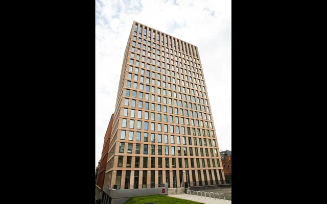 Modern brick high rise building with many windows exterior at Martha Street Apartments in Glasgow Student Accommodation