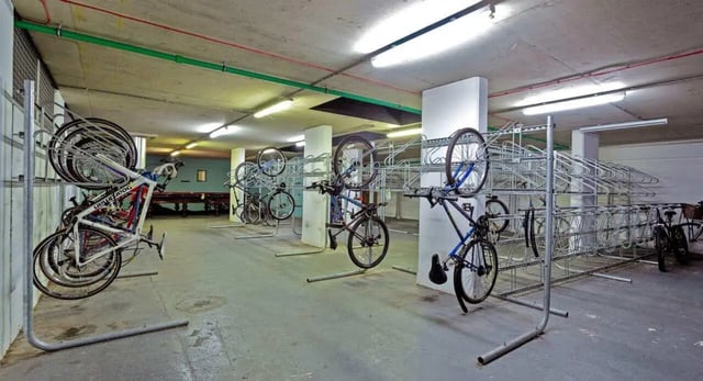 Bikes on racks underground storage Bicycle storage area at Griffon Studios in London Student Accommodation