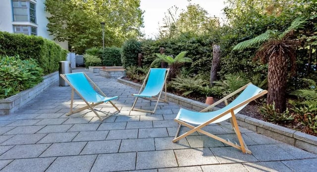 Blue deck chairs on patio outdoor area exterior at Griffon Studios in London Student Accommodation