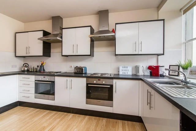 Modern kitchen with white cabinets, appliances, and sink kitchen at dwell Castle Gate Haus in Nottingham Student Accommodation