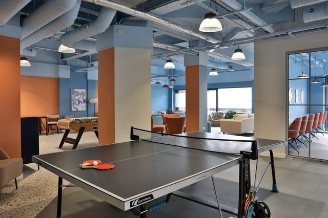 Ping pong table foosball chairs sofas lounge area at Ladybarn House in Manchester Student Accommodation