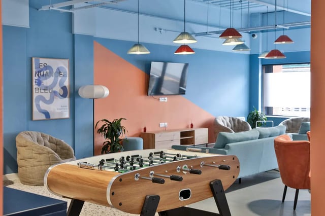 Foosball table sofa chairs modern communal living room at Ladybarn House in Manchester Student Accommodation
