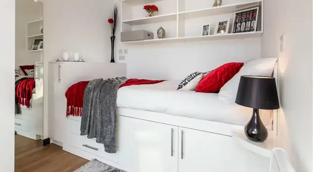 Bed with red pillows and blankets bedroom at The Court Yard in Southampton Student Accommodation