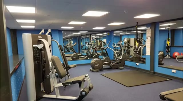 Gym equipment with mirrors and blue walls Gym at The Court Yard in Southampton Student Accommodation