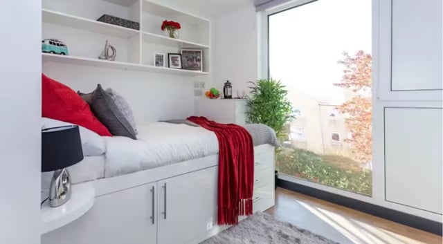 Bed with red blanket and pillows bedroom at The Court Yard in Southampton Student Accommodation