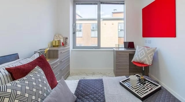 Bed desk chair pillows chest of drawers bedroom at Queens Gate in Southampton Student Accommodation