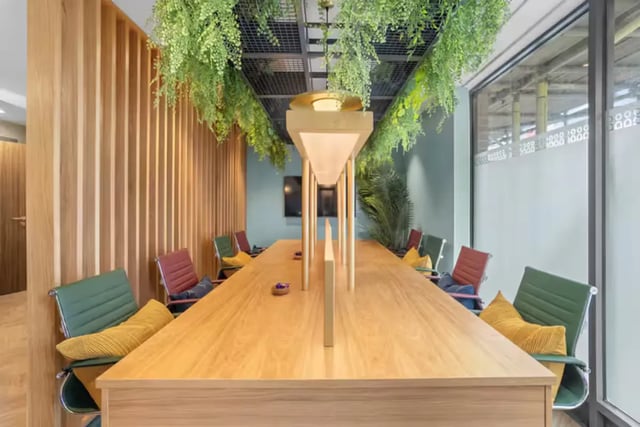 Long wooden table with chairs greenery study area at London Road Apartments in Southampton Student Accommodation