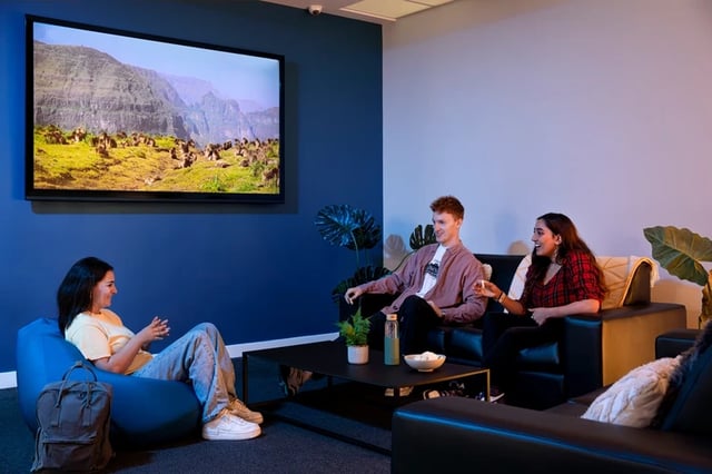 People relaxing in communal living room area at Orion Point in Southampton Student Accommodation