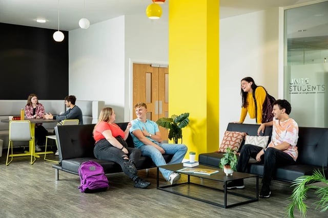Students conversing on sofas in a common area at Orion Point in Southampton Student Accommodation
