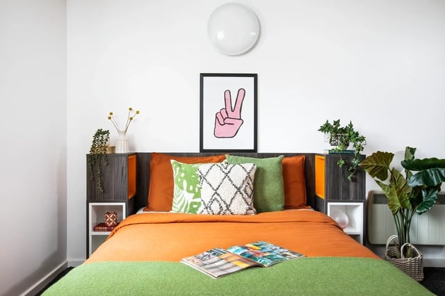 Orange bed with green accents and art Bedroom at Orion Point in Southampton Student Accommodation