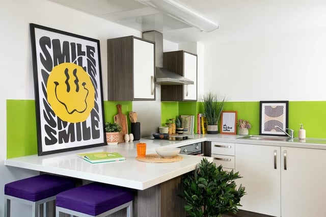 Smiley poster purple stools white kitchen island kitchen at Orion Point in Southampton Student Accommodation