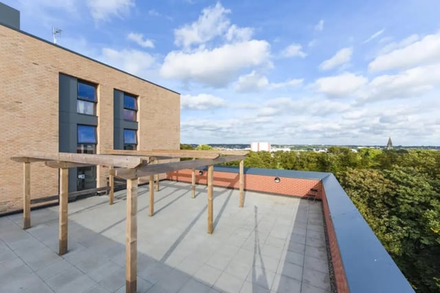 Wooden pergola with seating on tiled patio exterior at Vincent Place in Southampton Student Accommodation