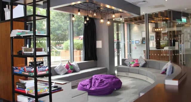 Gray sofas purple beanbag bookshelf living room at Vincent Place in Southampton Student Accommodation
