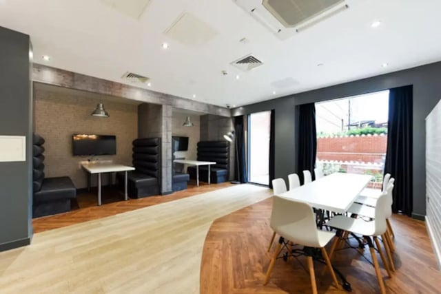 Booth seating with televisions meeting table and chairs common area at Vincent Place in Southampton Student Accommodation