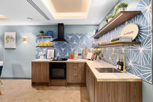 Modern student kitchen with patterned blue tile backsplash. at Brunswick Apartments in Southampton Student Accommodation