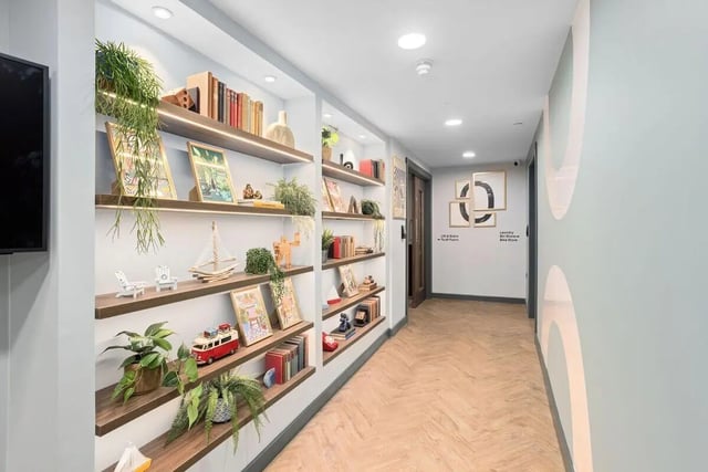 Shelving with plants books artwork corridor exterior at Brunswick Apartments in Southampton Student Accommodation
