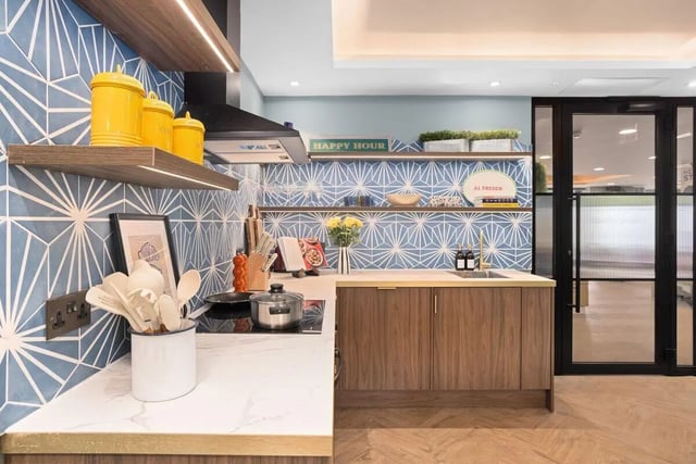 Blue tiled kitchen with wooden cabinets and sink kitchen at Brunswick Apartments in Southampton Student Accommodation