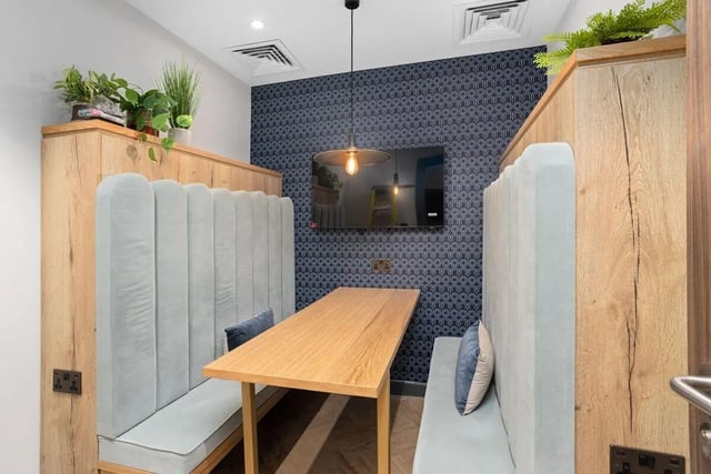 Booth seating and table with TV living area at Brunswick Apartments in Southampton Student Accommodation