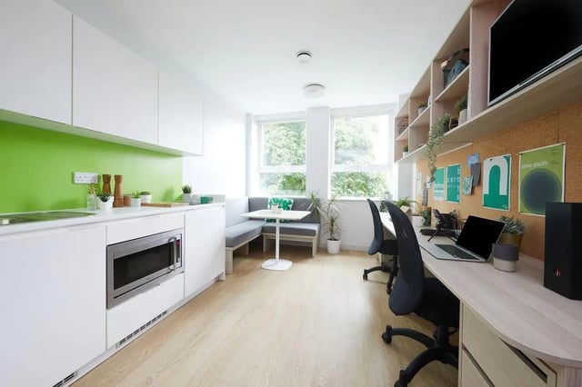 Kitchen study area with built-in seating and desks Living room at Collegiate Park House in Southampton Student Accommodation