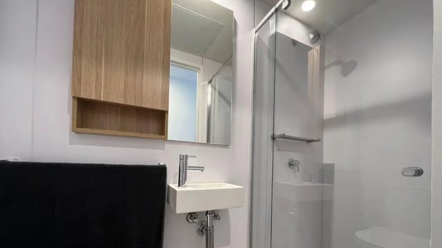 Sink mirror shower and towel bathroom at UniLodge Melbourne Central in Melbourne Student Accommodation