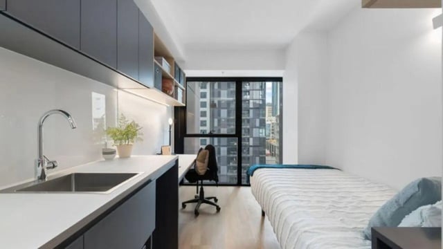 Sink desk bed and window view student accommodation at UniLodge Melbourne Central in Melbourne Student Accommodation
