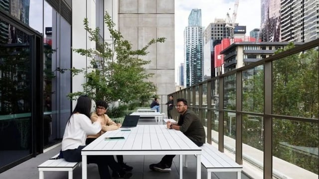 Students study at tables with laptops outdoor area at Unilodge Melbourne City in Melbourne Student Accommodation
