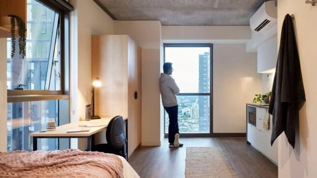 Bed desk wardrobe and kitchen student studio apartment at Unilodge Melbourne City in Melbourne Student Accommodation