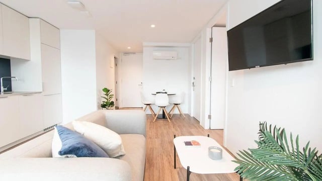 Sofa dining table kitchen and television living room at UniLodge Park Avenue in Melbourne Student Accommodation