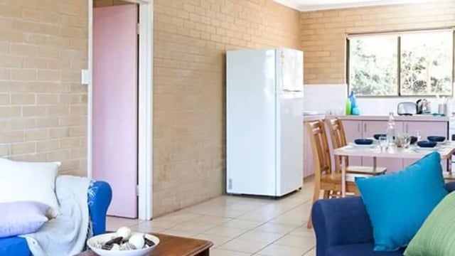 Sofa fridge dining table kitchen living area at Unilodge SCU Lismore Orion in Lismore Student Accommodation