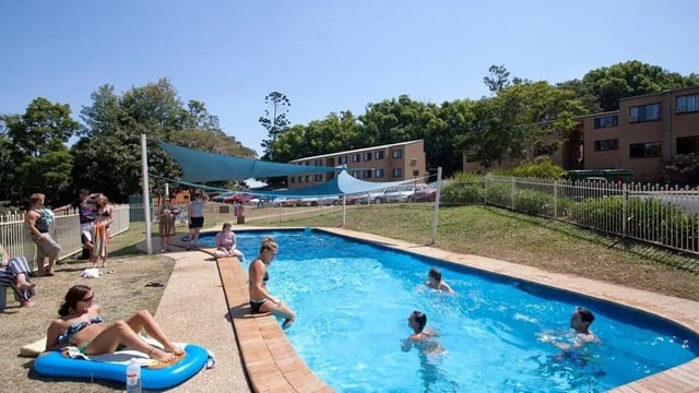 People swimming and relaxing at pool exterior at Unilodge SCU Lismore Orion in Lismore Student Accommodation