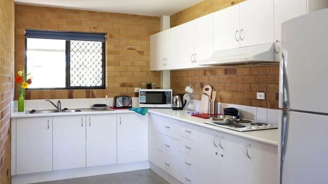 White cabinets sink microwave kettle stove refrigerator kitchen at Unilodge SCU Lismore Orion in Lismore Student Accommodation