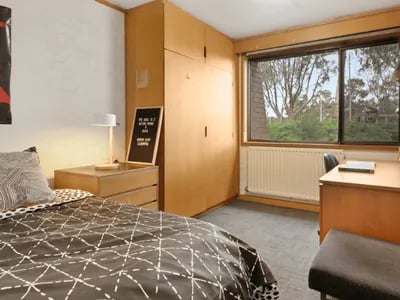 Bed nightstand lamp wardrobe desk bedroom at @the Lodge UNIVERSITY LIVING in Weatherford Student Accommodation