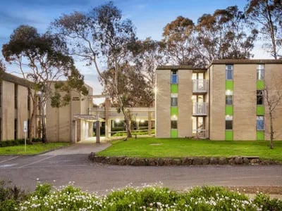 Student accommodation buildings with green accents exterior at La Trobe University - Glenn College in Melbourne Student Accommodation