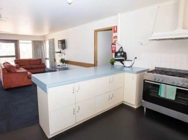 Sofa counter stove cabinetry with kitchen at La Trobe University - Terraces in Melbourne Student Accommodation