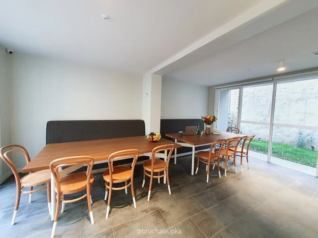 Wooden tables and chairs in communal area at UKO Paddington in Sydney Student Accommodation
