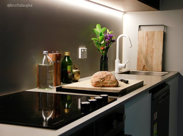 Bread olive oil flowers and tap kitchen counter Kitchen at UKO Paddington in Sydney Student Accommodation