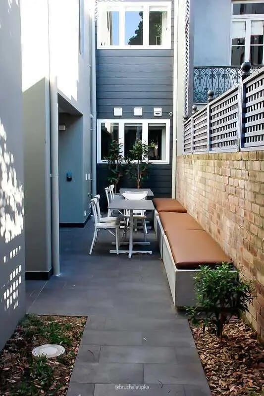 Outdoor seating area with table bench exterior at UKO Paddington in Sydney Student Accommodation