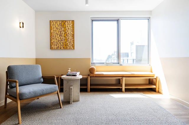 Grey armchair and bench near window living room at UKO Royal Park in Melbourne Student Accommodation