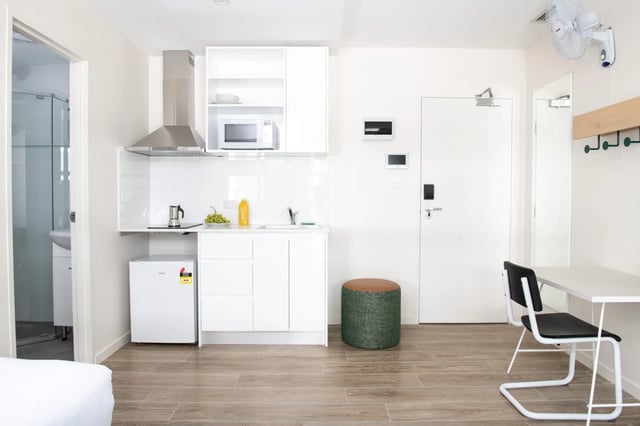Compact kitchen with microwave fridge and desk study area at UKO Stanmore in Sydney Student Accommodation